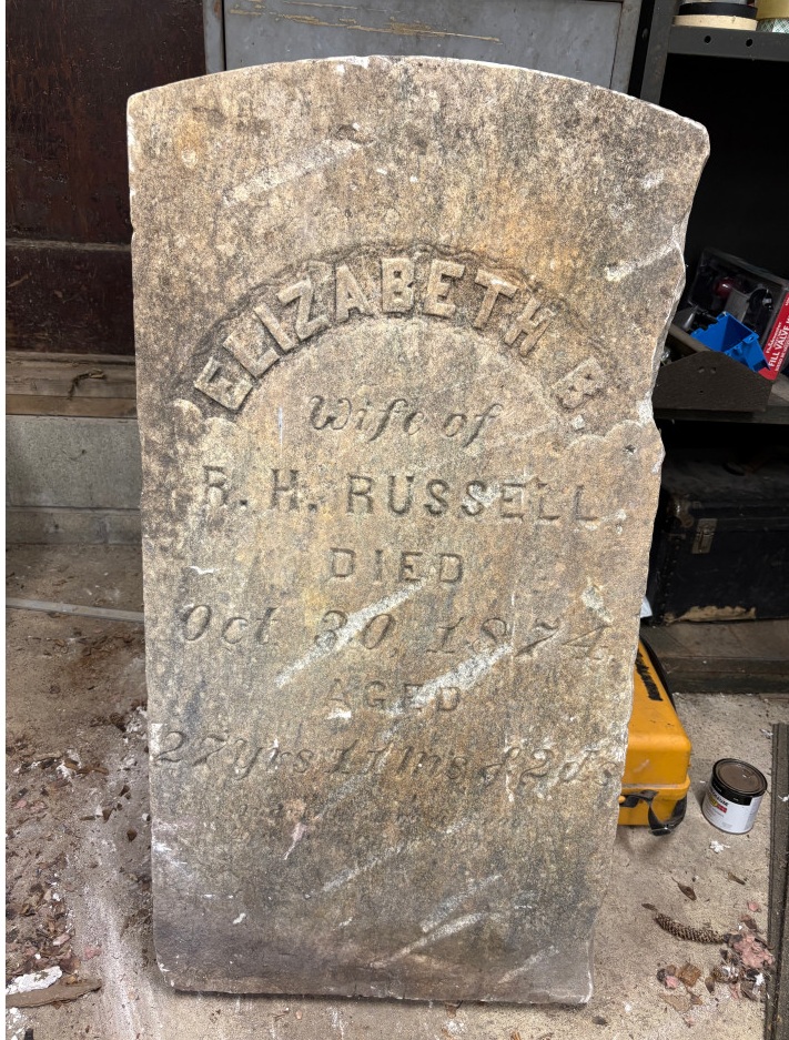 Old gravestone that reads Elizabeth B, wife of R.H. Russell, wife